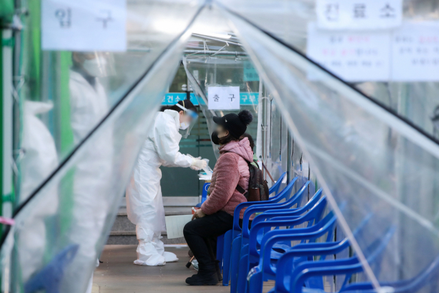 부산 지역 코로나19 신규확진자가 11명 발생한 19일 오후 부산 부산진구 보건소에 설치된 선별진료소에서 시민들이 검사를 받고 있다. 김경현 기자 view@