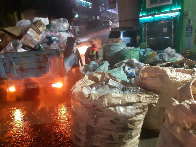 부산 북구의 한 쓰레기 수거업체가 재활용 선별장이 없어 도로에서 분리수거를 하고 있다. 재활용품 수거업체 제공