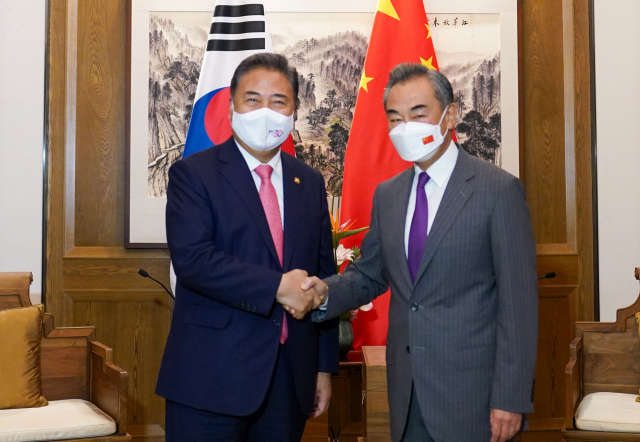 박진(왼쪽) 외교부 장관과 왕이 중국공산당 중앙정치국 위원이 지난해 중국에서 열린 양자 회담에 앞서 악수하고 있다. 외교부 제공