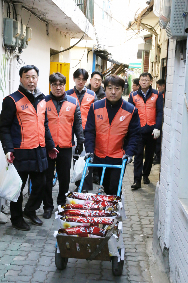 사랑의 쌀이 담긴 수레를 운반하는 홍원의 한전산업개발 사장. 한전산업개발 제공