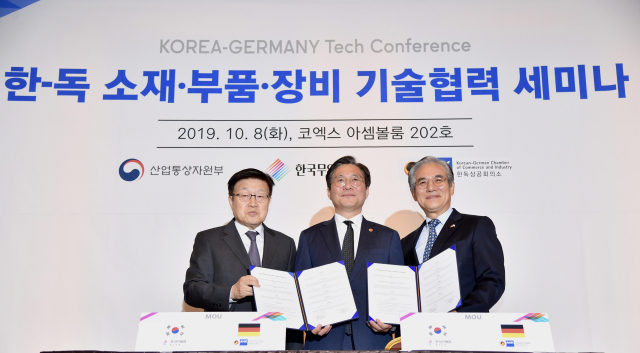 8일 서울 코엑스에서 열린 한·독 소재·부품·장비 기술협력 세미나에서 성윤모 산업통상자원부 장관(가운데)과 김영주 한국무역협회장(왼쪽), 김효준 한독상공회의 회장이 양국 소재·부품·장비 관련 기업 간 협력과 스타트업의 글로벌 오픈 이노베이션 협력에 관한 양해각서(MOU)를 체결한 뒤 기념촬영을 하고 있다. 한국무역협회 제공.