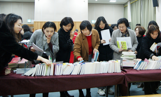 지난 15일 부산시립시민도서관에서 열린 ‘원북원부산’ 후보도서선정협의회. 오른쪽 책 사진은 2020 원북원부산 일반 부문 최종 후보도서로 선정된 <우리 몸이 세계라면> <오전을 사는 이에게 오후도 미래다> <나무의 시간>(위쪽부터). 부산시립시민도서관 제공