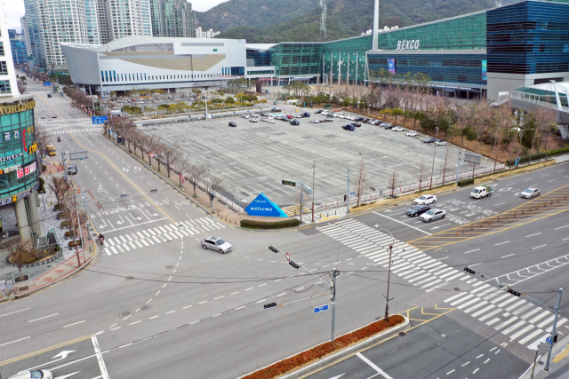 부산 마이스 산업의 메카인 벡스코 제1전시장 내부(왼쪽)와 야외 주차장이 3~5월 무더기 행사 취소로 텅텅 비어 한산한 모습을 보이고 있다. 정종회 기자 jjh@