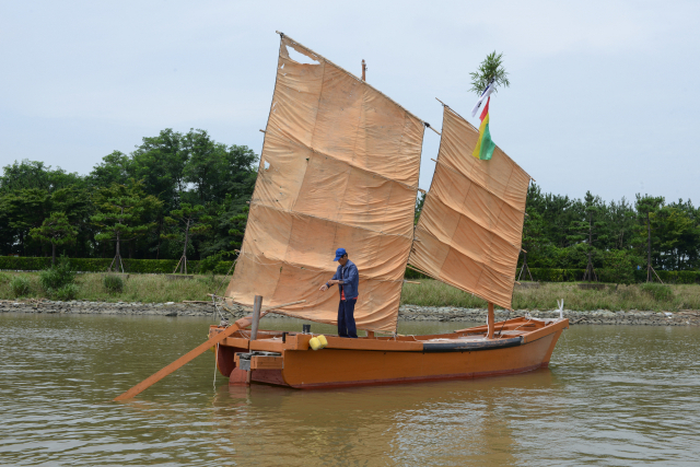 낙동강에서 직접 만든 황포돛배를 보여주고 있는 김창명 조선장. 국립해양박물관 제공