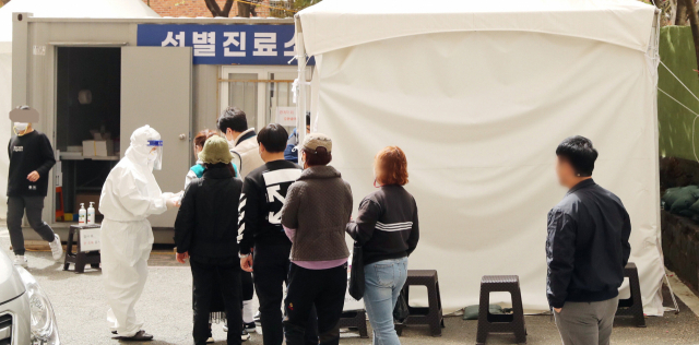 29일 오후 부산 서구보건소 선별진료소에서 시민들이 코로나19 검사를 받기 위해 줄지어 서 있다. 강원태 기자 wkang@