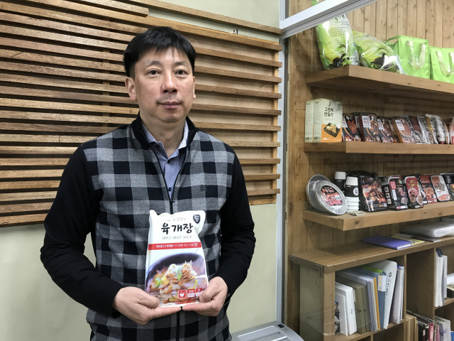 (주)에브리데이뉴 전기웅 대표가 참도깨비 시그니처라고 할 수 있는 ‘금강만두 육개장’을 들어보이고 있다. 이현정 기자