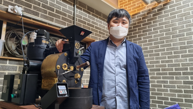 부산 부산진구 양정동에서 바리스타 학원을 운영하는 (사)한국커피협회 이호상(44) 이사가 커피 머신 옆에서 웃음짓고 있다. 이 씨는 부산이 커피 명품도시로 발돋움하기 위해서는 '커피 연구 전문가 육성'이 가장 큰 과제라고 강조했다. 손혜림 기자 hyerimsn@