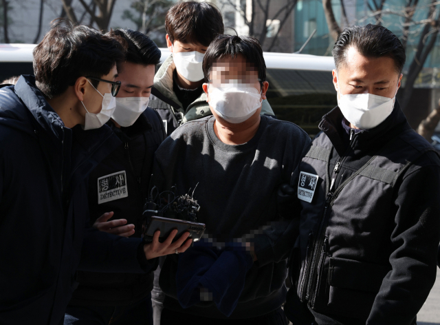 부모와 형을 살해한 뒤 스스로 신고한 30대 김 모 씨가 12일 오후 서울 양천구 남부지방법원에서 열린 영장실질심사에 출석하기 위해 법정으로 향하고 있다. 피의자 김 씨는 범행 사나흘 전 집 앞 마트에서 흉기를 구입한 것으로 알려졌다. 연합뉴스