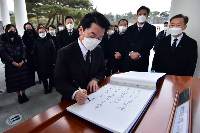 국민의당 안철수 대선 후보가 중앙선관위 후보 등록에 앞서 13일 국립서울현충원을 참배한 뒤 방명록을 작성하고 있다. 연합뉴스