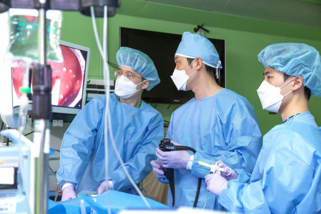 부산대병원 소화기내과 이문원(가운데) 교수가 내시경 시술을 하고 있다. 부산대병원 제공