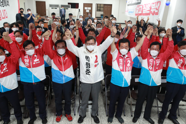 국민의힘 박형준 부산시장 후보를 비롯한선대위원장, 구청장 후보들이 1일 오후 부산 수영구 부산시당에서 출구조사가 발표되자 환호하고 있다. 연합뉴스