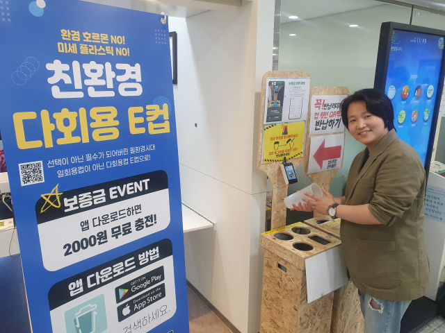 부산 친환경 스타트업 그린업 오민경 대표가 동래구청 내 카페에서 E컵 반납 시범을 보이고 있다.
