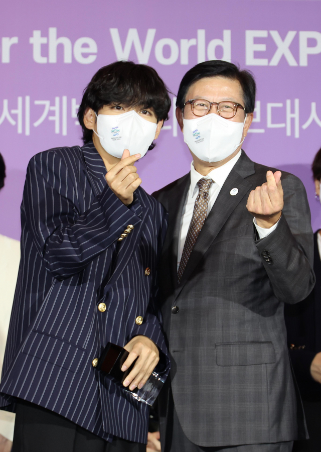 2030부산엑스포 홍보대사로 위촉된 BTS 제이홉이 엑스포유치위원회 공동위원장인 최태원 대한상공회의소 회장과 하트 포즈를 취하고 있다(위). 손하트를 하고 있는 BTS 뷔와 박형준 부산시장(아래). 연합뉴스