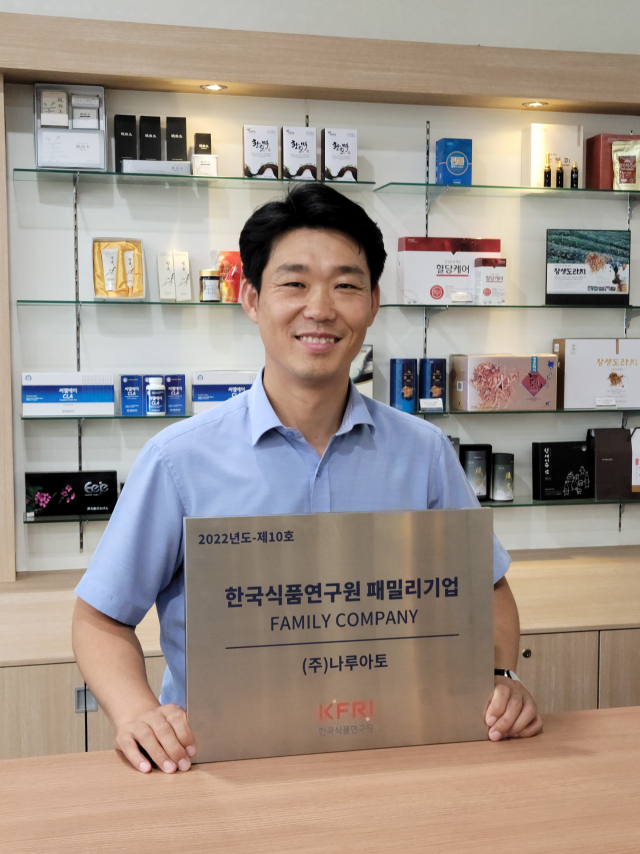 변홍주 나루아토 대표가 한국식품연구원 패밀리기업 지정 현판을 들고 기뻐하고 있다. 진주바이오산업진흥원 제공