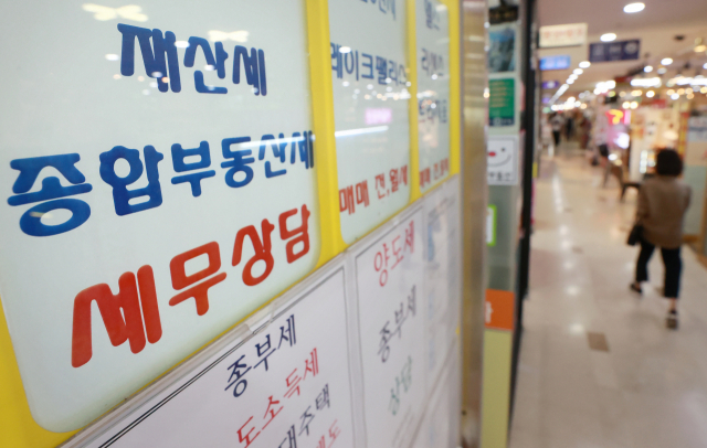 사진은 서울 시내 한 부동산중개업소에 붙은 종부세·재산세 상담 안내문. 연합뉴스