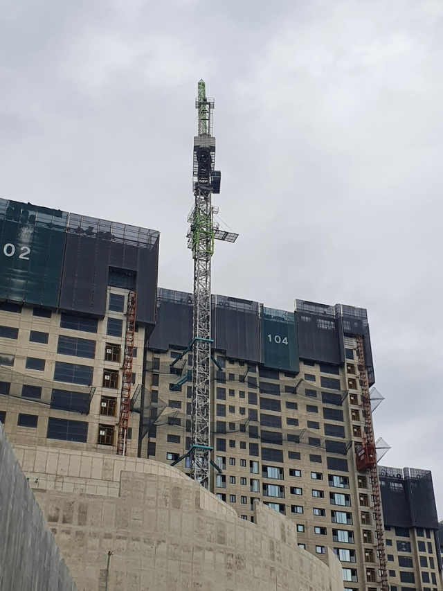 부산 남구의 한 아파트 공사 현장의 50m 높이 타워크레인에서 고공 농성 시위가 벌어지고 있다. 연합뉴스