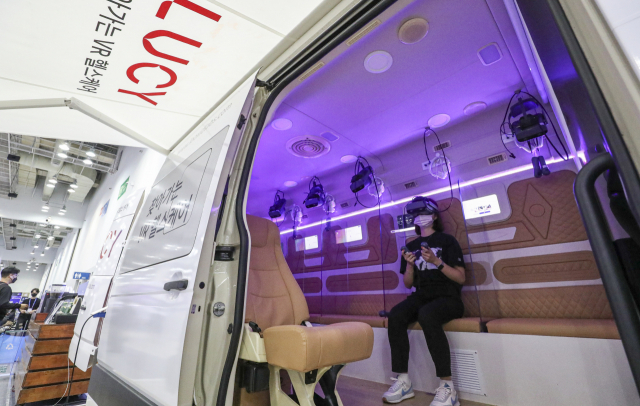 'K-ICT Week in BUSAN 2022'가 개막한 28일 부산 해운대구 벡스코 제2전시장에서 관람객이 찾아가는 VR헬스케어 시스템 차량을 체험하고 있다.