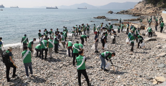 HJ중공업 임직원들이 29일 오후 부산 영도구 중리해변에서 지난 태풍 때 떠밀려온 비닐, 플라스틱, 폐어구, 스티로폼 등 각종 해양쓰레기를 줍는 ‘플로킹 캠페인’을 펼치고 있다. 이재찬 기자 chan@
