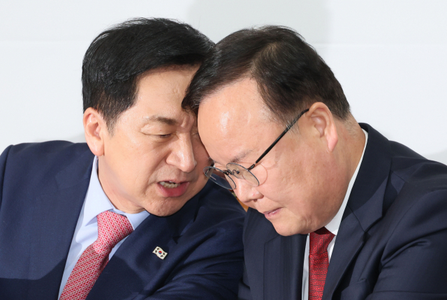 국민의힘 김기현 대표가 지난 20일 오전 국회에서 열린 최고위원회의에서 김재원 최고위원과 귀엣말을 나누고 있다. 연합뉴스