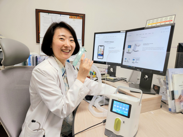 쉐어앤서비스 최희은 대표가 부산 해운대구 좌동 인제대 해운대백병원 재활의학과 사무실에서 만성폐쇄성 폐 질환자의 호흡을 도와주는 휴대형 호흡 재활 의료기기 ‘이지브리드’를 들고 설명하고 있다.