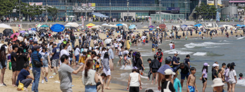 현충일 징검다리 연휴 마지막 날인 지난 6일 오후 부산 해운대해수욕장에서 관광객들이 해수욕을 즐기고 있다. 지난 1일 임시 개장한 해운대해수욕장과 송정해수욕장을 시작으로 오는 7월 1일 부산지역 7개 해수욕장이 전면 개장한다. 부산일보DB