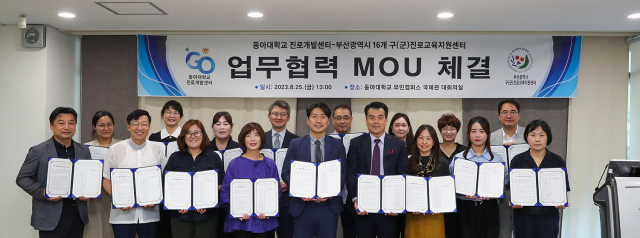 동아대 조규판(앞줄 오른쪽에서 네 번째) 진로개발센터 소장과 부산광역시 16개 구·군 진로교육지원센터 관계자들이 업무협약 기념촬영을 하고 있다