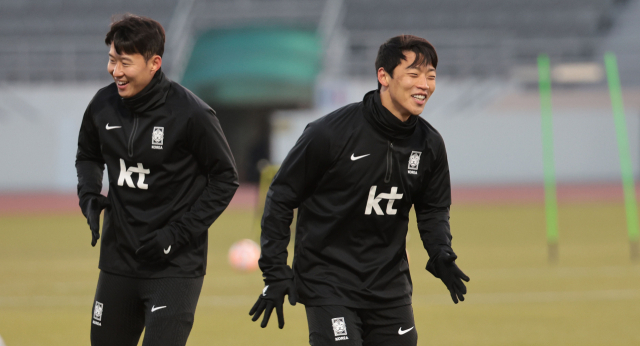 한국 축구 대표팀의 황희찬(오른쪽)과 손흥민이 13일 서울 양천구 목동종합운동장에서 2026 북중미 월드컵 아시아 2차 예선 싱가포르와의 경기를 앞두고 환한 표정으로 훈련하고 있다. 연합뉴스