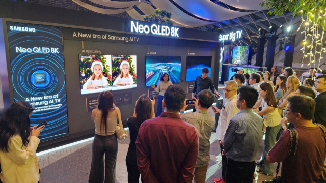 싱가포르공항 내 복합문화공간 쥬얼 창이 방문객들이 삼성전자 ‘2024년형 네오 QLED 8K’ 제품 설명을 듣고 있다.삼성전자 제공