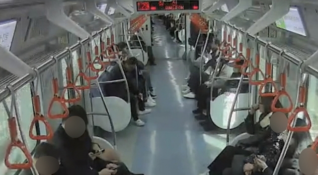 지난 9일 낮 12시 25분께 부산 금정구 장전동 도시철도 1호선 부산대역 부근을 지나던 전동차 내에서 50대 남성이 불 붙인 종이를 바닥에 내려놓고 있다. 부산교통공사 제공