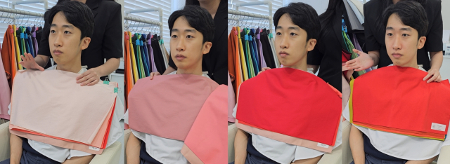 ※얼굴 주의. 색조 화장을 하지 않은 적나라한 상태에서 받아본 드레이핑. 선생님은 내 얼굴에 노란기가 많고 혈색이 없다는 ‘팩트폭행’을 날려줬는데, 왼쪽 첫 번째의 연한 파스텔 톤이나 두 번째 탁한 색상은 이런 약점을 강조하는 느낌이야. 고채도의 빨강인 왼쪽 세 번째는 조금 더 낫지만 여전히 얼굴에 노란기가 돌고, 중채도인데다 회색기 없이 맑은 네 번째 ‘토마토 레드’가 베스트라는 진단이야. 조경건 부산닷컴 기자