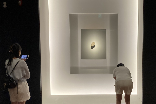 두 여성이 경북 경주시 국립경주박물관에 전시된 얼굴무늬 수막새 ‘신라의 미소’를 살펴보고 있다. 남태우 기자