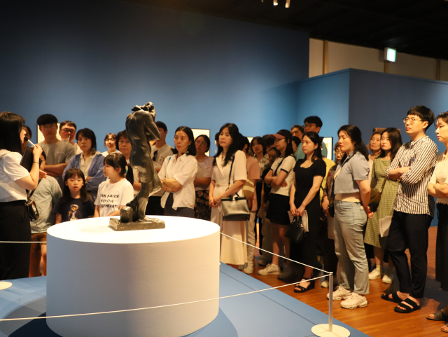 ‘모네에서 앤디워홀까지’전에서 도슨트 설명을 듣고 있는 관람객들 모습. 부산문화회관 제공