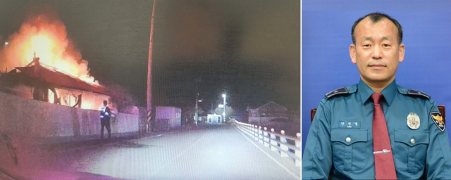 안진열(오른쪽) 경위가 지난 12일 경남 통영시 사량면 하도 덕동마을 주택 화재 현장에서 진화를 시도하고 있다. 통영경찰서 제공