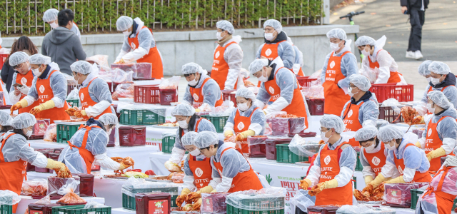부산지역 롯데 계열사 23곳의 임직원과 시민단체, 자원봉사자 등 150여 명이 3일 오전 부산 동래구 사직야구장 정문광장에서 1만포기 김장나눔에 동참하고 있다.