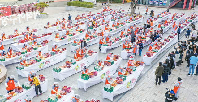 부산지역 롯데 계열사 23곳의 임직원과 시민단체, 자원봉사자 등 150여 명이 3일 오전 부산 동래구 사직야구장 정문광장에서 1만포기 김장나눔에 동참하고 있다.