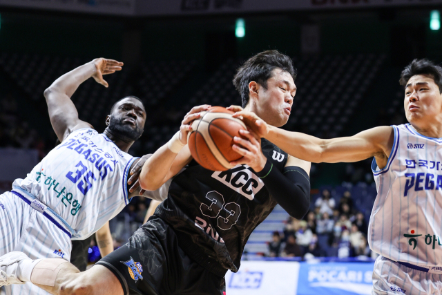 부산 KCC의 이승현(가운데)이 22일 부산 사직체육관에서 열린 대구 한국가스공사의 경기에서 상대 선수와 볼 다툼을 벌이고 있다. KBL제공