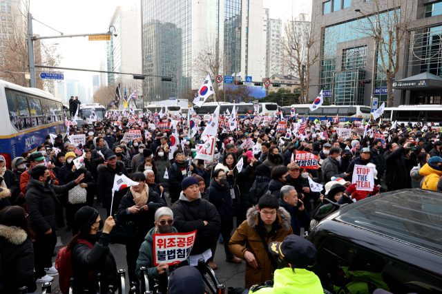 내란 우두머리 혐의로 체포된 윤석열 대통령의 구속 전 피의자심문(영장실질심사)이 열린 18일 서울 마포구 서울서부지방법원 앞에서 윤 대통령 지지자들이 집회를 하고 있다. 연합뉴스