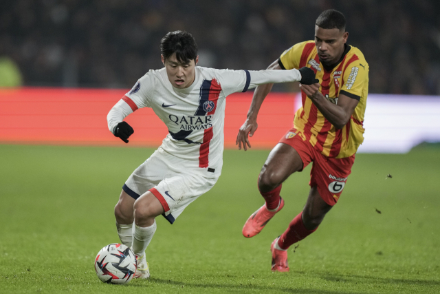 PSG의 이강인이 19일(한국시간) 프랑스 리그1 랑스와 원정 경기에서 상대 선수를 제치고 돌파를 시도하고 있다. AP연합뉴스