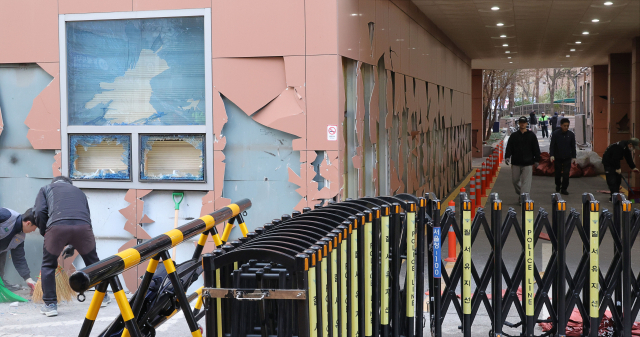 윤석열 대통령이 내란 우두머리 혐의로 구속되자 일부 윤 대통령 지지자들이 서울서부지방법원 내부로 난입해 불법폭력사태를 일으킨 19일 오후 서부지법에서 청사 관계자들이 파손된 시설물과 물품 등을 치운 뒤 복구작업을 하고 있다. 연합뉴스