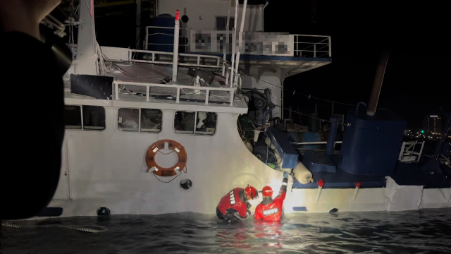 21일 오후 9시 30분께 통영시 장좌부두에 계류 중인 23t급 예인선이 침몰했다. 출동한 해양경찰 구조대가 선내를 살피고 있다. 통영해양경찰서 제공