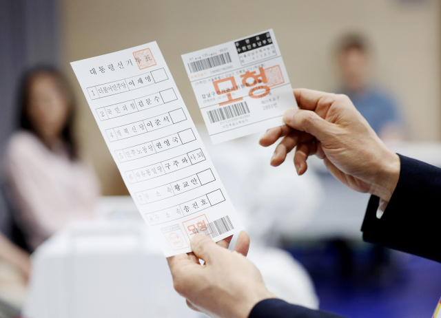 오민석 서울시선거관리위원장이 28일 서울 관악구 신사동 복합청사에 설치된 사전투표소에서 제21대 대통령선거 사전투표 투표용지를 확인하고 있다. 연합뉴스