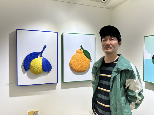 부산 동구 낭만시간연구소에서 전시 중인 작품 앞에서 포즈를 취한 변대용 작가. 김은영 기자