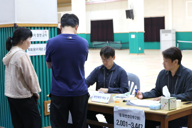 제21대 대통령선거 투표일인 3일 오후 울산 남구 월평초등학교 체육관에 설치된 신정4동 제2투표소에서 유권자들이 투표를 위해 본인확인하고 있다. 연합뉴스