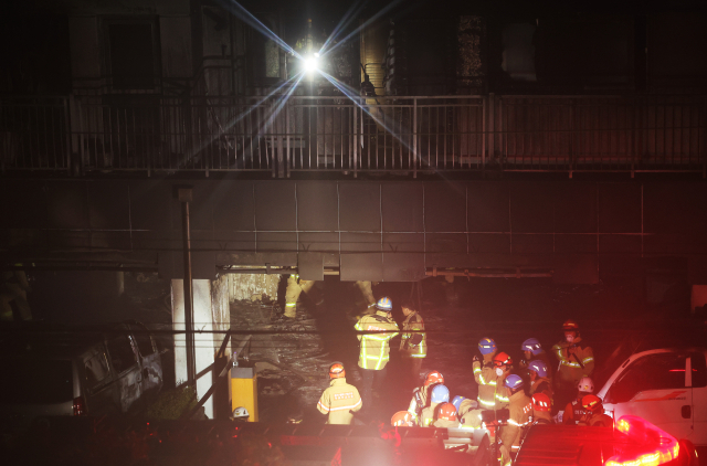 주차장에서 화재가 발생한 경기도 광명시 소하동 한 아파트에서 18일 소방관들이 인명 수색 등을 위해 분주하게 움직이고 있다. 연합뉴스