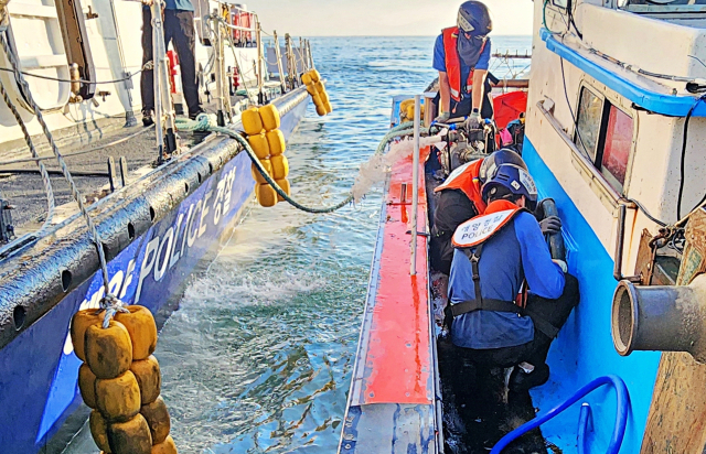 24일 오전 6시 29분 통영시 오곡도 북방 0.5해리 해상에서 19t급 어획물운반선과 3.27t급 연안통발어선이 충돌했다. 출동한 해경 대원들이 선체에 들어찬 바닷물을 빼내고 있다. 통영해양경찰서 제공