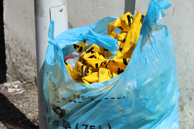 지난달 29일 낮 12시 8분 대전 서구 괴정동 주택가에서 한 남성이 30대 여성을 흉기로 찌르고 도주했다. 사진은 현장에 쳐놨던 폴리스라인이 쓰레기봉투에 버려져 있는 모습. 연합뉴스
