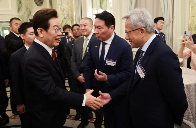 이재명 대통령이 25일(현지시간) 미국 워싱턴DC 윌라드 호텔에서 열린 한미 비즈니스 라운드 테이블에서 젠슨 황 엔비디아 최고경영자와 악수하고 있다. 가운데는 최태원 대한상공회의소 회장 겸 SK그룹 회장. 연합뉴스
