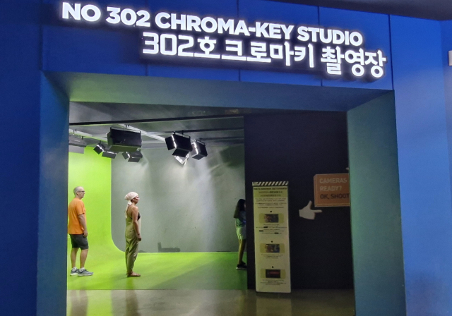 부산영화체험박물관 크로마키 촬영장에서 프랑스 가족 방문객이 자신들만의 영화 예고편을 찍고 있다. 김희돈 기자