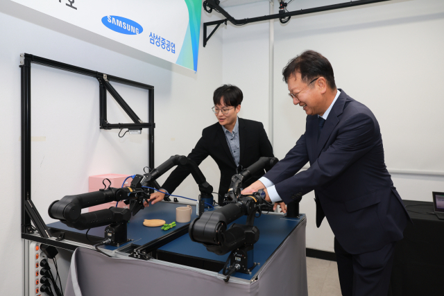 삼성중공업 최성안 대표이사 부회장이 부산대학교 양팔모방학습로봇을 직접 체험해 보고 있다. 삼성중공업 제공