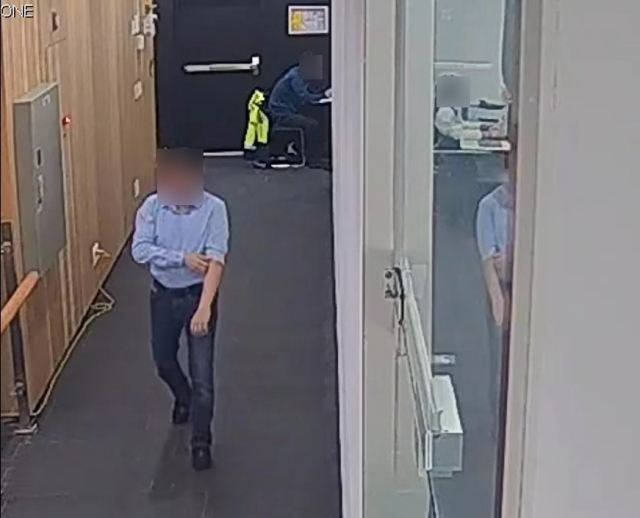 2023년 12월 12일 카자흐스탄 부산 총영사관에서 아얀 카샤바예프 초대 총영사(왼쪽)가 팔소매를 걷으며 사무실로 향하고 있다. 이후 총영사관에 근무하던 계약직 직원 A 씨를 폭행하는 모습이 화면에 포착됐다. 해당 건물 CCTV 캡처